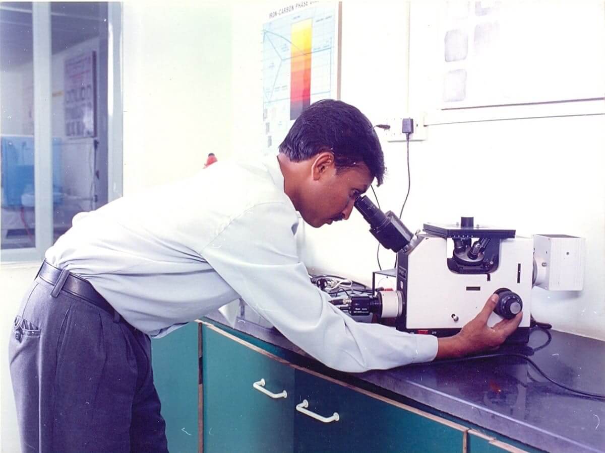 Metallugical Engineer Observing Microstructure under microscope