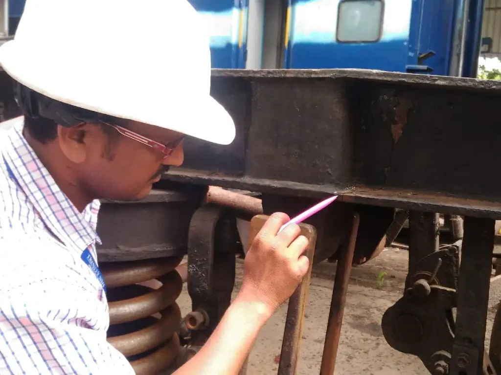 A visual inspector Level II certified carrying out Inservices Inspection of Bogie Railway Parts during Training at Trinity NDT WeldSolutions Bangalore India